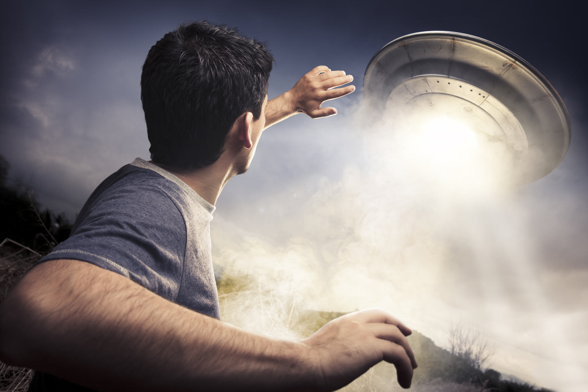 a man about to be abducted by a flying saucer